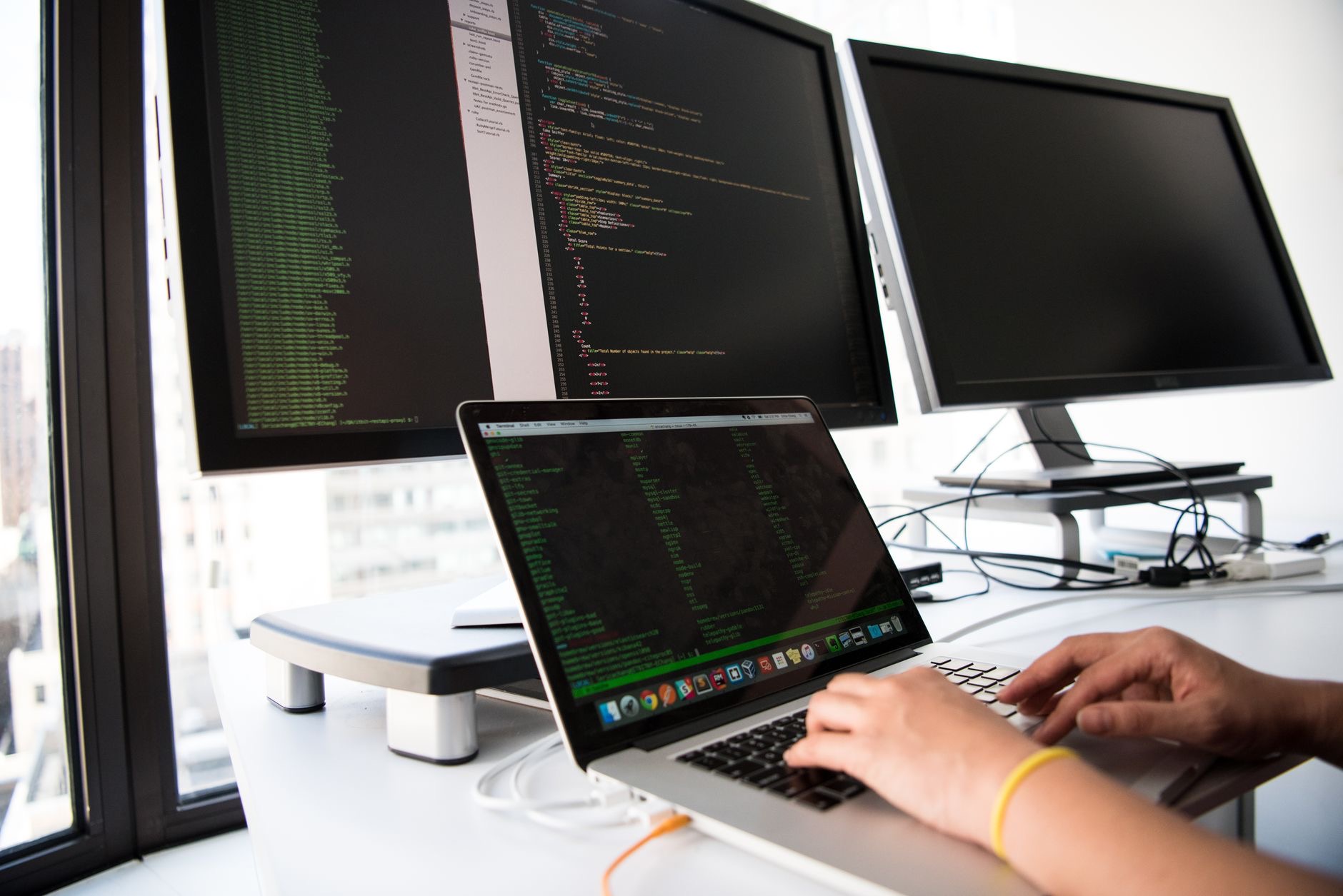 software engineers testing applications on multiple computer screens