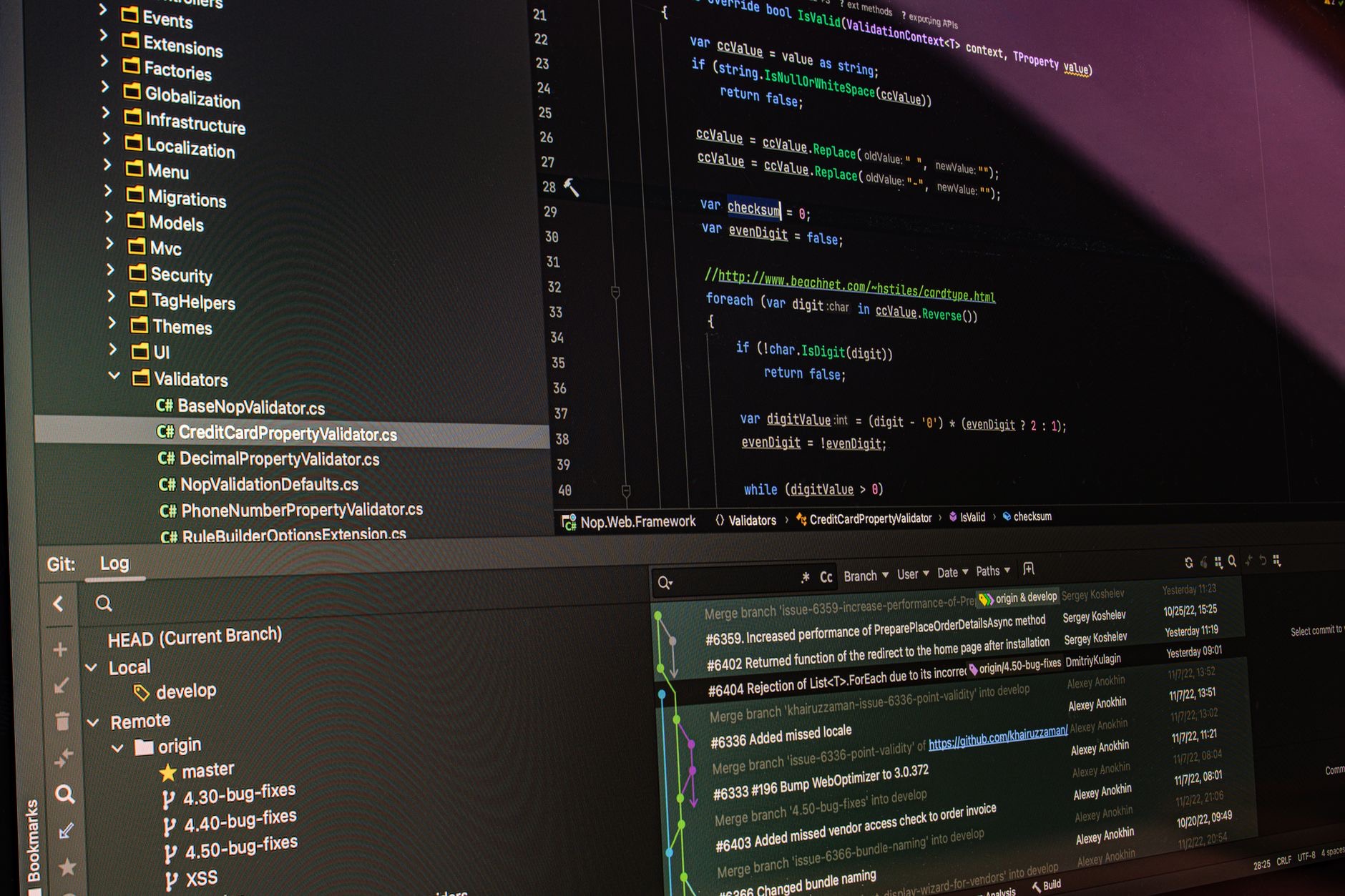 Software source code and version-control dashboard on a computer monitor